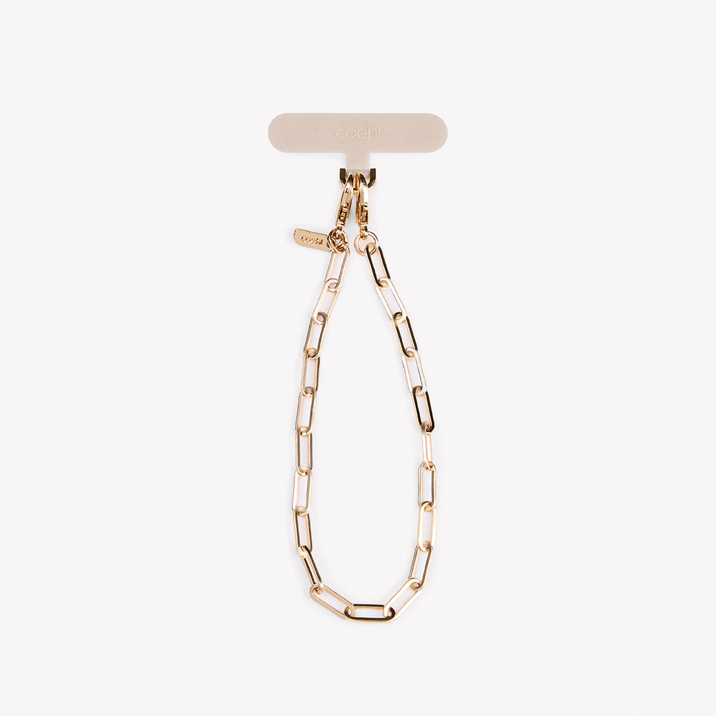 Gold Goldilocks Universal Phone Charm. Featuring a timeless champagne gold hue and intricate interlocking chains, it’s the perfect accessory for any modern style.