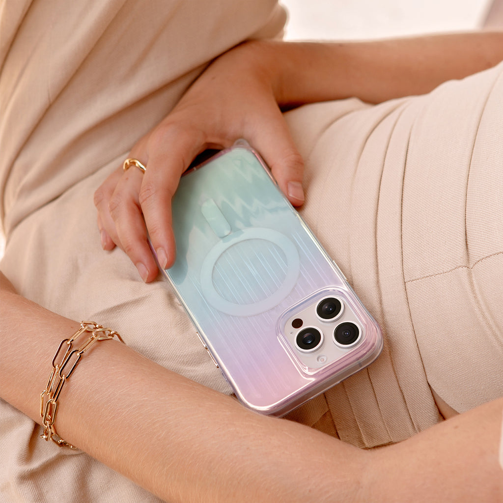 A lifestyle image of the LINEAR phone case with wristlet, made for the iPhone 16, available in iridescent color