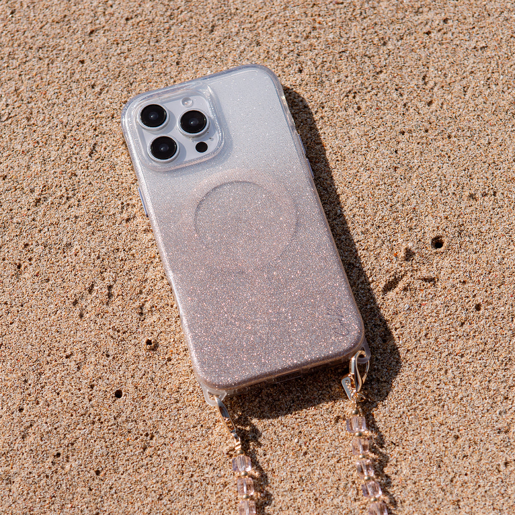 A lifestyle image of the LUMINO— the iPhone 16 Pro case with the phone wristlet, available in sparkling silver color